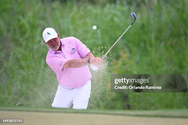 Darren Clarke of Northern Ireland plays a shot from a bunker on the 13th hole during the third round of the KitchenAid Senior PGA Championship at...