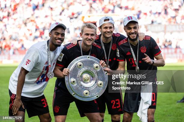 Ryan Gravenberch, Matthijs de Ligt, Daley Blind and Noussair Mazraoui of FC Bayern Munchen pose with the Bundesliga Champions Trophy afterthe...