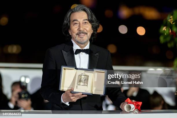 Kōji Yakusho poses with the Best Actor Award for 'Perfect Days' during the Palme D'Or winners photocall at the 76th annual Cannes film festival at...