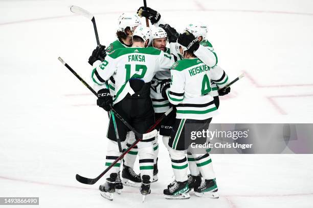 Luke Glendening of the Dallas Stars is congratulated by his teammates after scoring a goal against the Vegas Golden Knights during the first period...