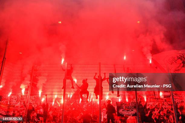 Paris Saint-Germain fans wave flares during the Ligue 1 match between RC Strasbourg and Paris Saint-Germain at Stade de la Meinau on May 27, 2023 in...