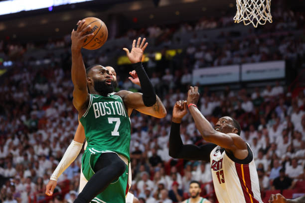 Jaylen Brown of the Boston Celtics drives to the net over Bam Adebayo of the Miami Heat during the second quarter in game six of the Eastern...