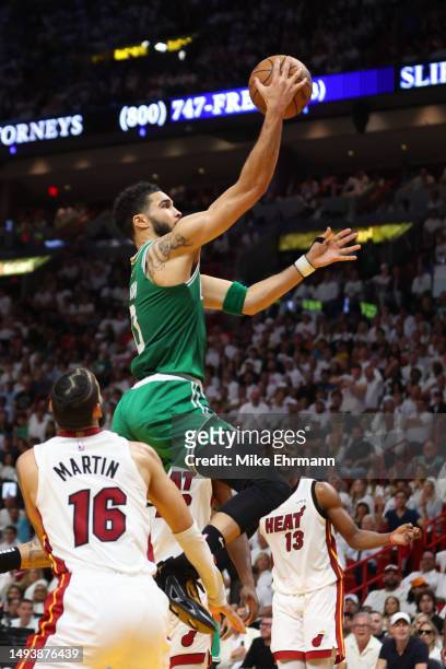 Jayson Tatum of the Boston Celtics drives to the net ahead of Jimmy Butler of the Miami Heat during the second quarter in game six of the Eastern...