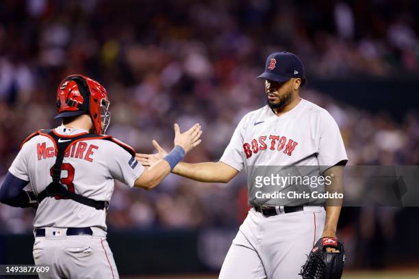 Catcher Reese McGuire of the Boston Red Sox shakes hands with pitcher Kenley Jansen after the Red Sox defeated the Arizona Diamondbacks 2-1 at Chase...