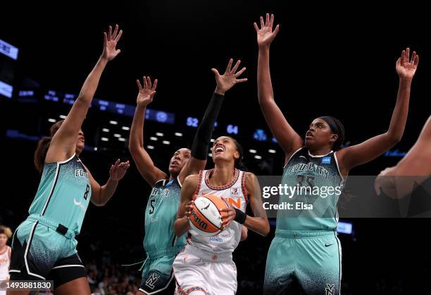 DeWanna Bonner of the Connecticut Sun heads for the net as Nyara Sabally, Kayla Thornton and Jonquel Jones of the New York Liberty defend at Barclays...