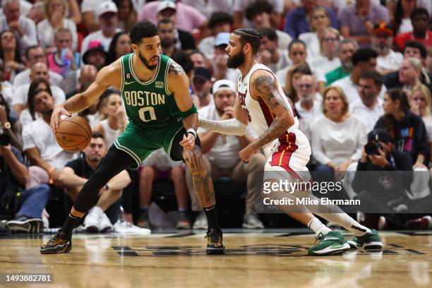 Caleb Martin of the Miami Heat defends Jayson Tatum of the Boston Celtics during the third quarter in game six of the Eastern Conference Finals at...