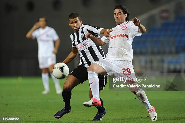 Medhi Abeid of Newcastle United competes with Andreas Tatos of Olympiacos during a pre-Season friendly match between Newcastle United and Olympiacos...