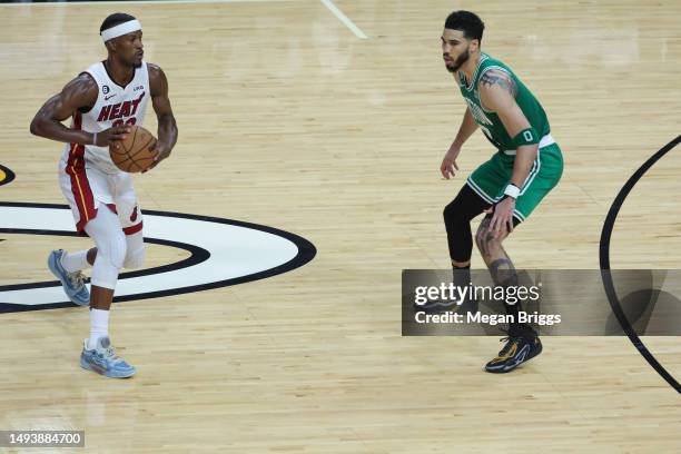 Jimmy Butler of the Miami Heat controls the ball against Jayson Tatum of the Boston Celtics in game six of the Eastern Conference Finals at Kaseya...