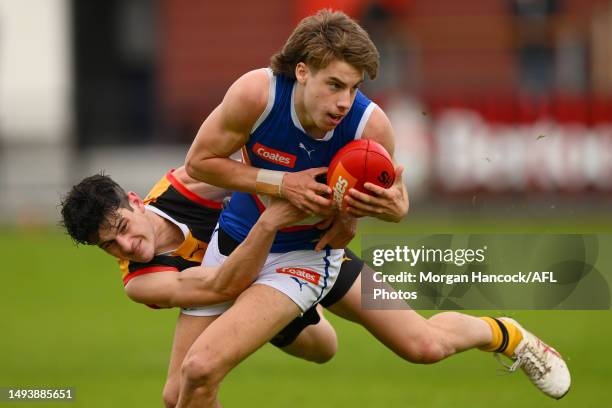 Matthew Nelson of the Stingrays tackles Caleb Windsor of the Ranges during the round eight Coates Talent League match between Dandenong Stingrays and...