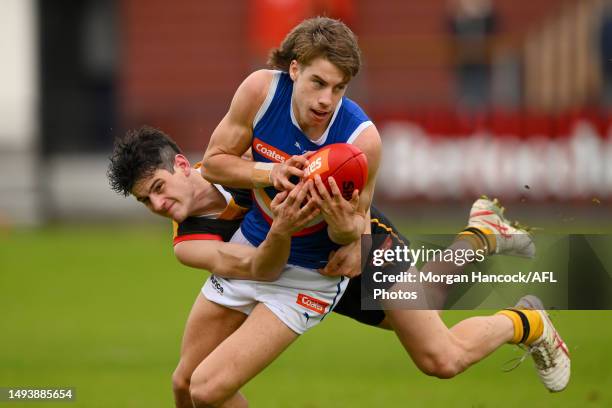 Matthew Nelson of the Stingrays tackles Caleb Windsor of the Ranges during the round eight Coates Talent League match between Dandenong Stingrays and...