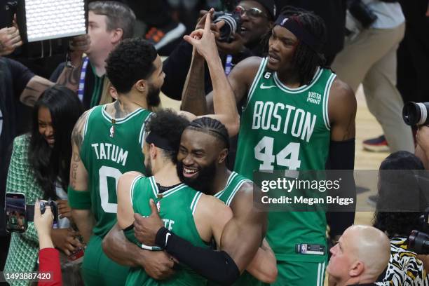 Derrick White and Jaylen Brown of the Boston Celtics react after defeating the Miami Heat 104-103 in game six of the Eastern Conference Finals at...