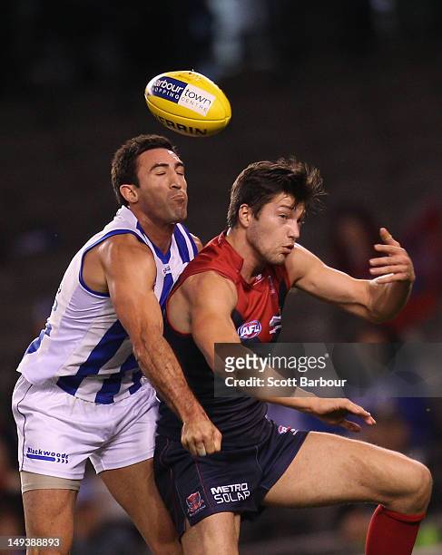 Michael Firrito of the Kangaroos and Stefan Martin of the Demons compete for the ball during the round 18 AFL match between the North Melbourne...