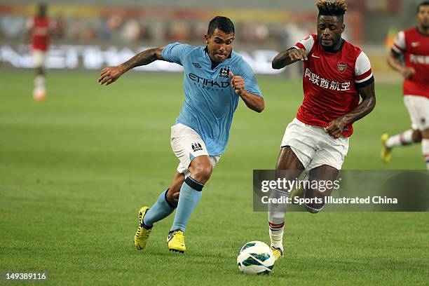 Tevez of Manchester City in action with Alexandre Song of Arsenal FC during the pre-season Asian Tour friendly match between Arsenal and Manchester...