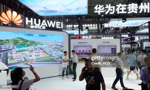 People visit Huawei booth during the China International Big Data Industry Expo 2023 at Guiyang International Convention & Exhibition Center on May...