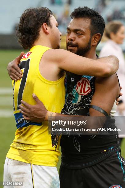 Daniel Rioli of the Tigers and Junior Rioli of the Power embrace after the round 11 AFL match between Richmond Tigers and Yartapuulti / Port Adelaide...