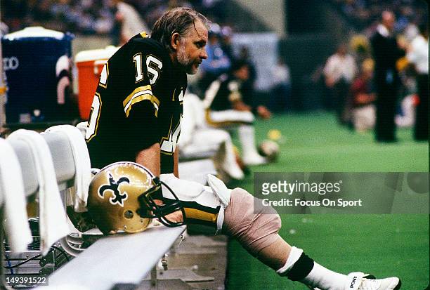 Quarterback Ken Stabler of the New Orleans Saints looks on from the bench during an NFL football game circa 1984 at the Louisiana Superdome in New...