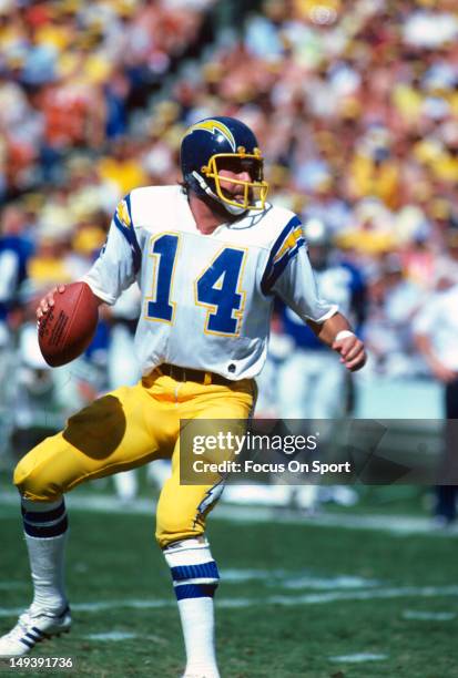 Dan Fouts of the San Diego Chargers drops back to pass against the Seattle Seahawks during an NFL football game circa 1980 at Jack Murphy Stadium in...