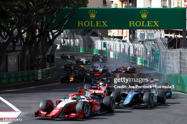 Frederik Vesti of Denmark and PREMA Racing leads Victor Martins of France and ART Grand Prix and the rest of the field into turn one at the start...
