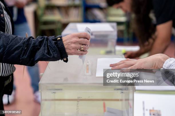 Person places his vote in the ballot box at a polling station on May 28 in Madrid, Spain. Today, 28M, municipal elections are being held in Spain in...