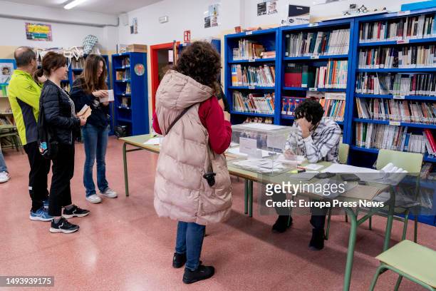 Several people approach the voting table at a polling station on May 28 in Madrid, Spain. Today, 28M, municipal elections are being held in Spain in...