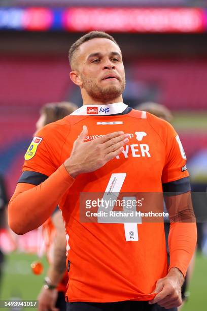 Carlton Morris of Luton wear 's the shirt of Tom Lockyer after the team's victory and promotion to the Premier League in the Sky Bet Championship...