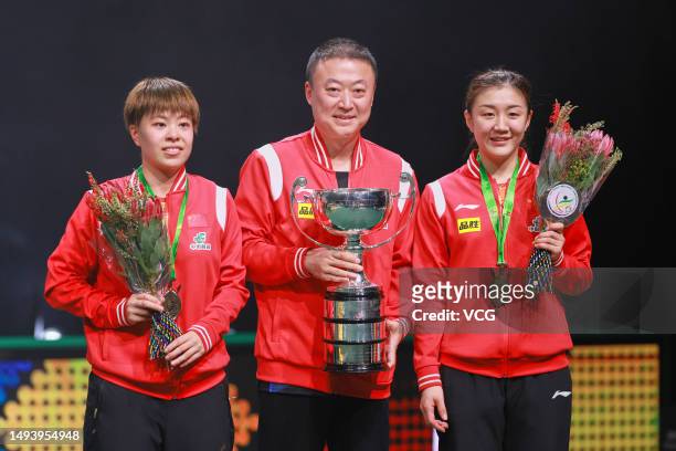 Gold medalists Chen Meng and Wang Yidi of China celebrate with their coach Ma Lin during medal ceremony for the Women's Doubles final match on day 8...