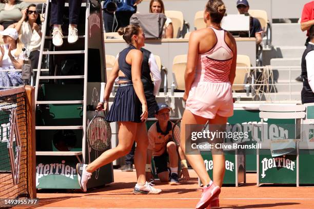 Marta Kostyuk of Ukraine walks past Aryna Sabalenka after their Women's Singles First Round Match on Day One of the at Roland Garros on May 28, 2023...