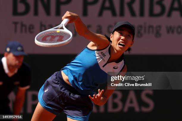 Shuai Zhang of People's Republic of China serves against Magdalena Frech of Poland during their Women's Singles First Round Match on Day One of the...