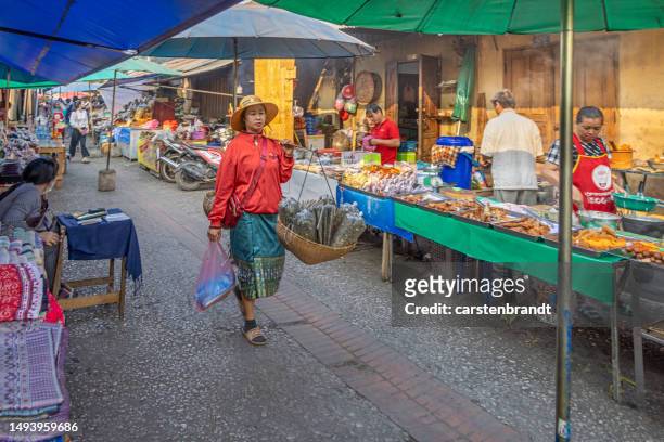 femme avec un bâton de transport un marché matinal à un moment calme - all people photos et images de collection