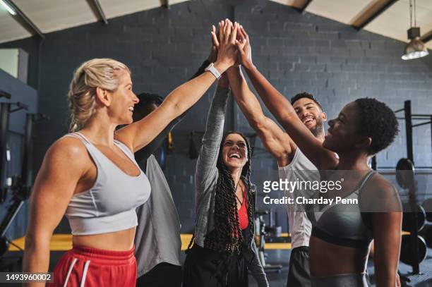 group of cheerful friends giving high five in gym - black man high 5 stockfoto's en -beelden