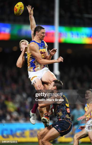 Joe Daniher of the Lions gets the sit on Tom Doedee of the Crows as his mark id spoiled by Nick Murray of the Crows during the round 11 AFL match...