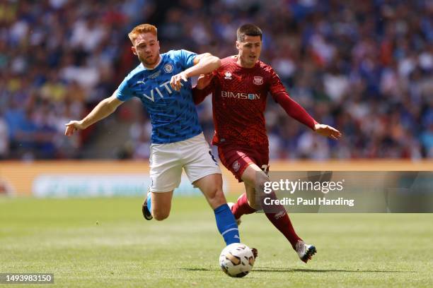 Callum Camps of Stockport County battles for possession with Jon Mellish of Carlisle United during the Sky Bet League Two Play-Off Final between...