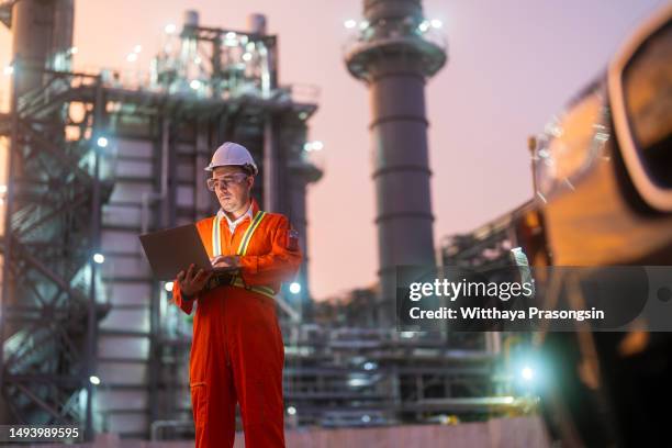 male engineer using laptop during night shift - arab engineer stock pictures, royalty-free photos & images