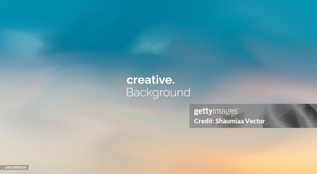 Blurred skyscape defocused background with orange yellow light clouds