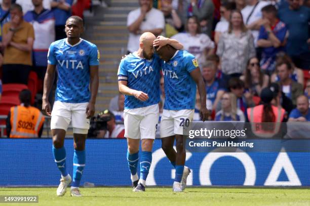 Isaac Olaofe of Stockport County celebrates with teammate Paddy Madden after Jon Mellish of Carlisle United scores an own goal during the Sky Bet...