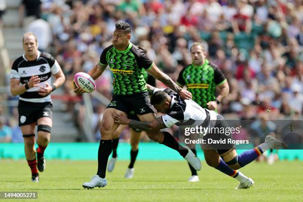 Israel Folau of World XV is tackled by Tevita Li of Barbarians during the Kilik Cup match between Barbarians and World XV at Twickenham Stadium on...