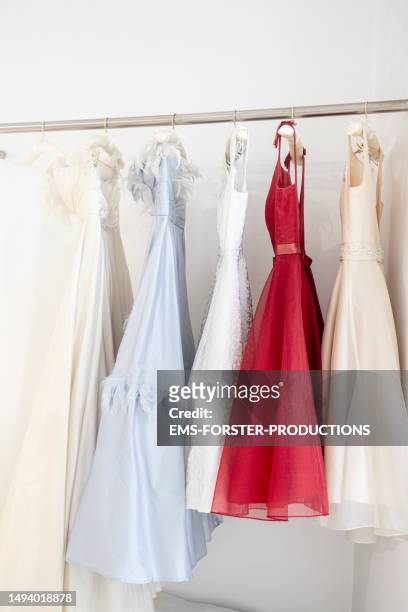 clothes rail full with wedding dresses and evening dresses - wedding dress store stock pictures, royalty-free photos & images