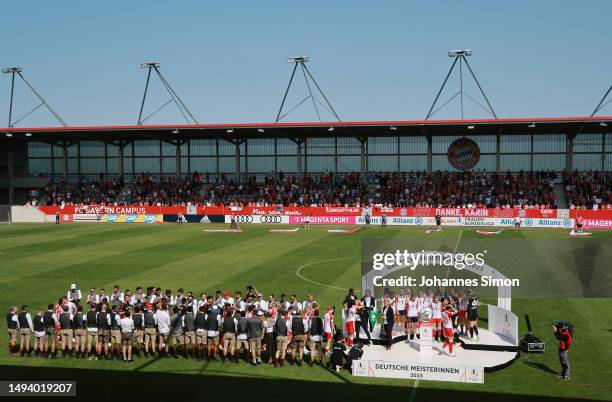 Players of FC Bayern Munich Women receive a guard of honour from Players of FC Bayern Munich prior to being presented with the FLYERALARM...