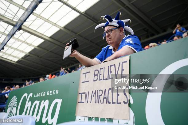 Leicester City fan looks on with a banner reading 'I believe in miracles' prior to the Premier League match between Leicester City and West Ham...