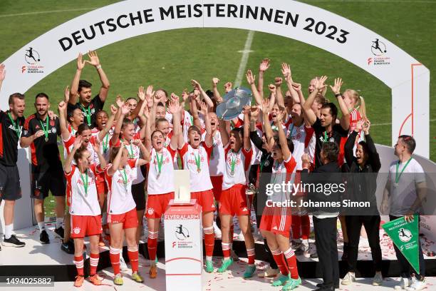 Jovana Damnjanovic of FC Bayern Munich lifts the Frauen-Bundesliga trophy after their team's victory in the FLYERALARM Frauen-Bundesliga match...