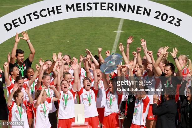 Jovana Damnjanovic of FC Bayern Munich lifts the Frauen-Bundesliga trophy after their team's victory in the FLYERALARM Frauen-Bundesliga match...