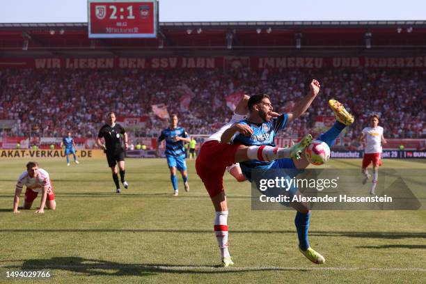 Jan Elvedi of Jahn Regensburg and Tim Kleindienst of 1. FC Heidenheim 1846 battle for the ball during the Second Bundesliga match between SSV Jahn...