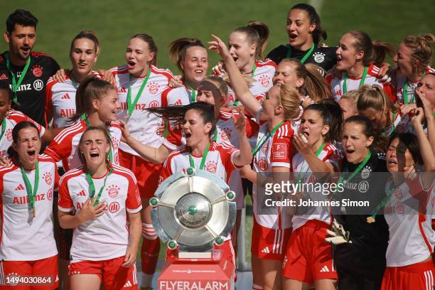 Sarah Zadrazil of FC Bayern Munich lifts the Frauen-Bundesliga trophy after their team's victory in the FLYERALARM Frauen-Bundesliga match between FC...