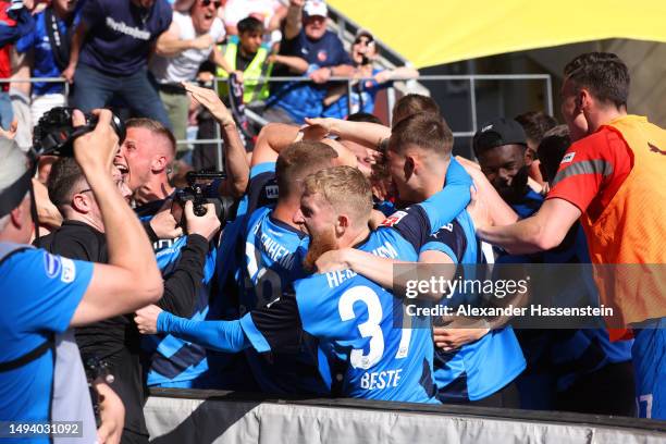 Tim Kleindienst of 1. FC Heidenheim 1846 celebrates with teammates after scoring the team's third goal during the Second Bundesliga match between SSV...