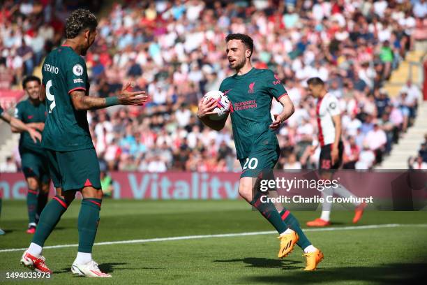 Diogo Jota of Liverpool celebrates with teammate Roberto Firmino after scoring the team's first goal during the Premier League match between...