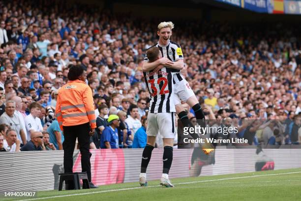 Anthony Gordon of Newcastle United celebrates with teammate Elliot Anderson after scoring the team's first goal during the Premier League match...