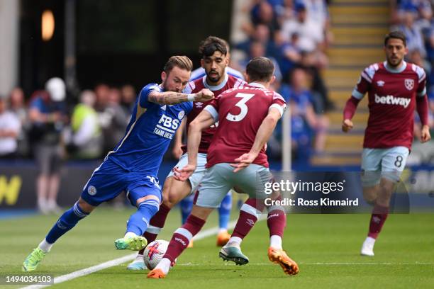 James Maddison of Leicester City runs with the ball from Lucas Paqueta of West Ham United during the Premier League match between Leicester City and...