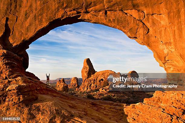 hiker in north window arch - arches national park fotografías e imágenes de stock