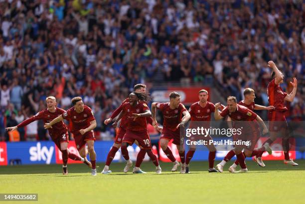 Carlisle United players celebrate following the team's victory in the penalty shoot out, resulting in their promotion to League One, during the Sky...