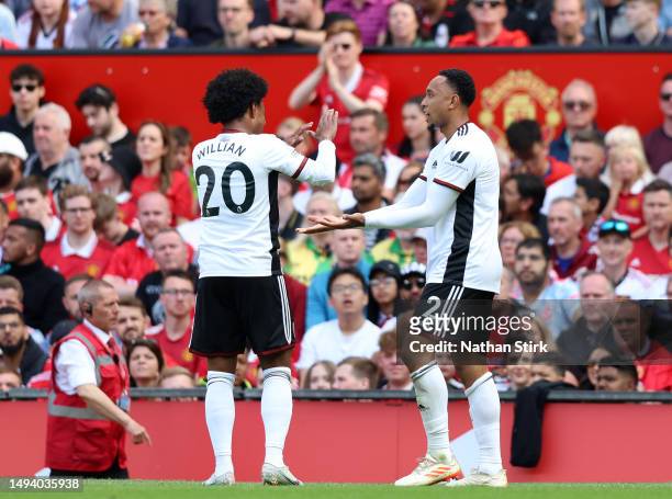 Kenny Tete of Fulham celebrates with teammate Willian after scoring the team's first goal during the Premier League match between Manchester United...
